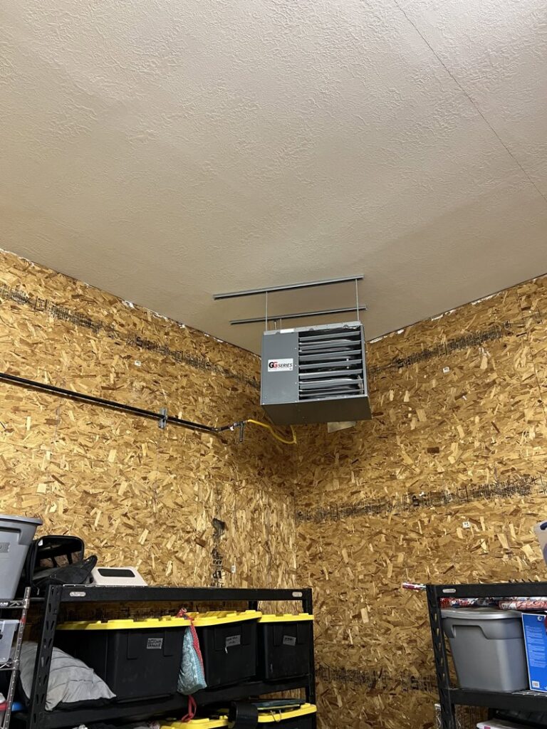 A garage unit heater installed on the ceiling of a garage by TriForce HVAC in Layton, UT