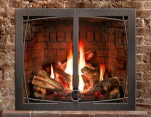 A gas fireplace insert with a decorative metal frame and burning logs, installed by North Central Service, Inc. in Minot, ND.