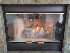 A gas fireplace featuring mesh screens and active flames, installed or serviced by Precision Energy LLC in Everett, WA.