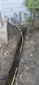 New gas line installation in a trench leading to a house by Bowers Heating and Air Conditioning in Wichita, KS
