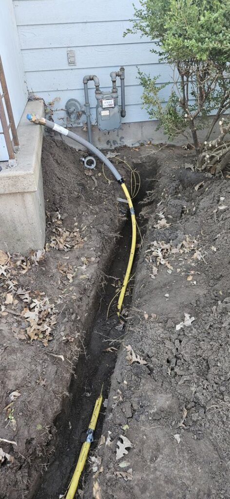 New gas line installation in a trench leading to a house by Bowers Heating and Air Conditioning in Wichita, KS