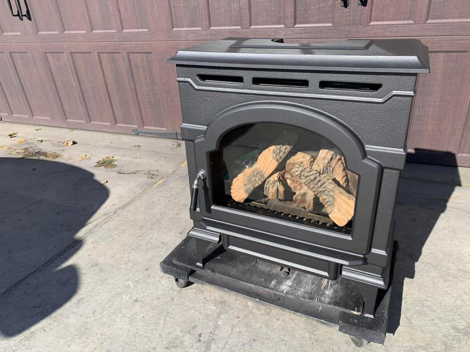 A gas stove on a dolly, ready for delivery or installation by Wood Stoves For Sale in Fairbanks, AK.