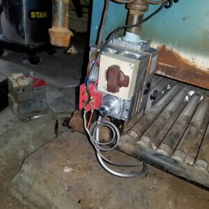 A close-up of a gas valve and piping on an HVAC boiler, serviced by Batista Heating & Cooling, LLC. in Charlotte, NC.
