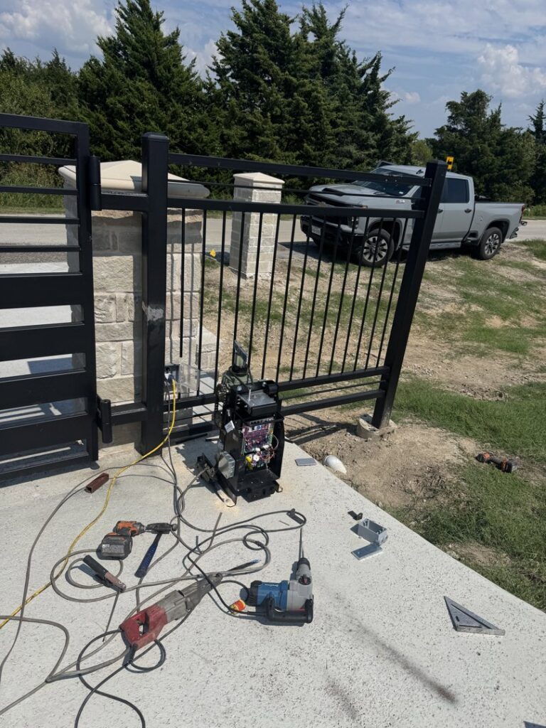 Gate installation in progress with welding equipment and tools on site by HDR Systems Gate, Fence & Garage doors in Plano, TX