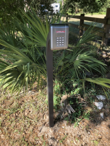 A gate keypad entry system installed on a post by Big Bear Automatic Gates, LLC in La Belle, FL.