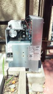 Close-up of an installed gate opener motor with a product label by Automated Entry Systems Inc in Escondido, CA.
