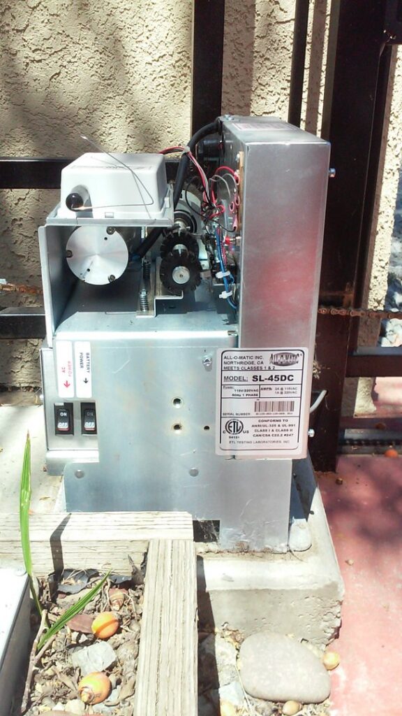 Close-up of an installed gate opener motor with a product label by Automated Entry Systems Inc in Escondido, CA.