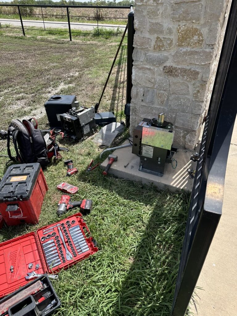Gate operator repair or installation in progress with tools on the ground by HDR Systems Gate, Fence & Garage doors in Plano, TX
