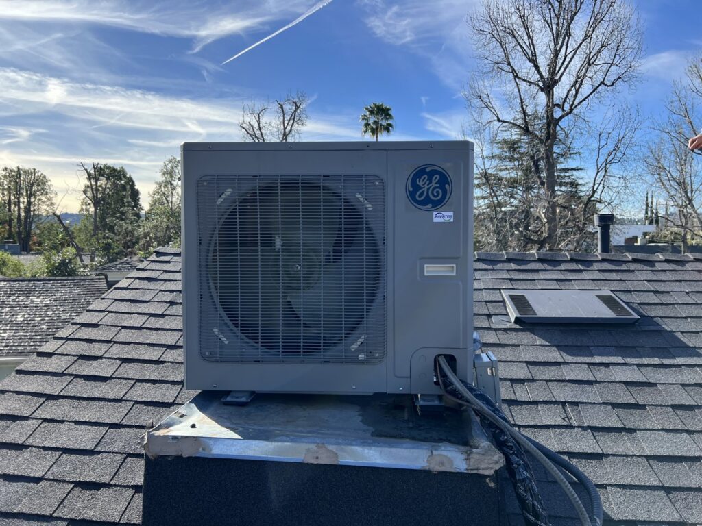 A GE Inverter HVAC outdoor unit installed on a rooftop by Affordable Heating and Air in Chatsworth, CA.