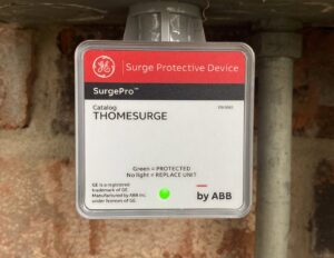 A GE Surge Protective Device installed on an exterior wall, providing electrical protection by Outlaw Home Services, LLC in San Antonio, Tx.