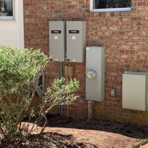 Generac electrical panels and meter installation on a brick house by Oak Electric LLC in Waterford, MI.