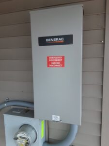 A Generac emergency disconnect and service disconnect panel installed on the side of a house by Great Lakes Power Generation in Williamsburg, MI.