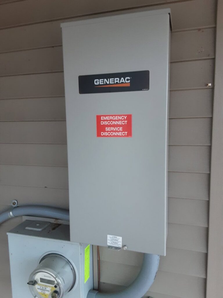 A Generac emergency disconnect and service disconnect panel installed on the side of a house by Great Lakes Power Generation in Williamsburg, MI.