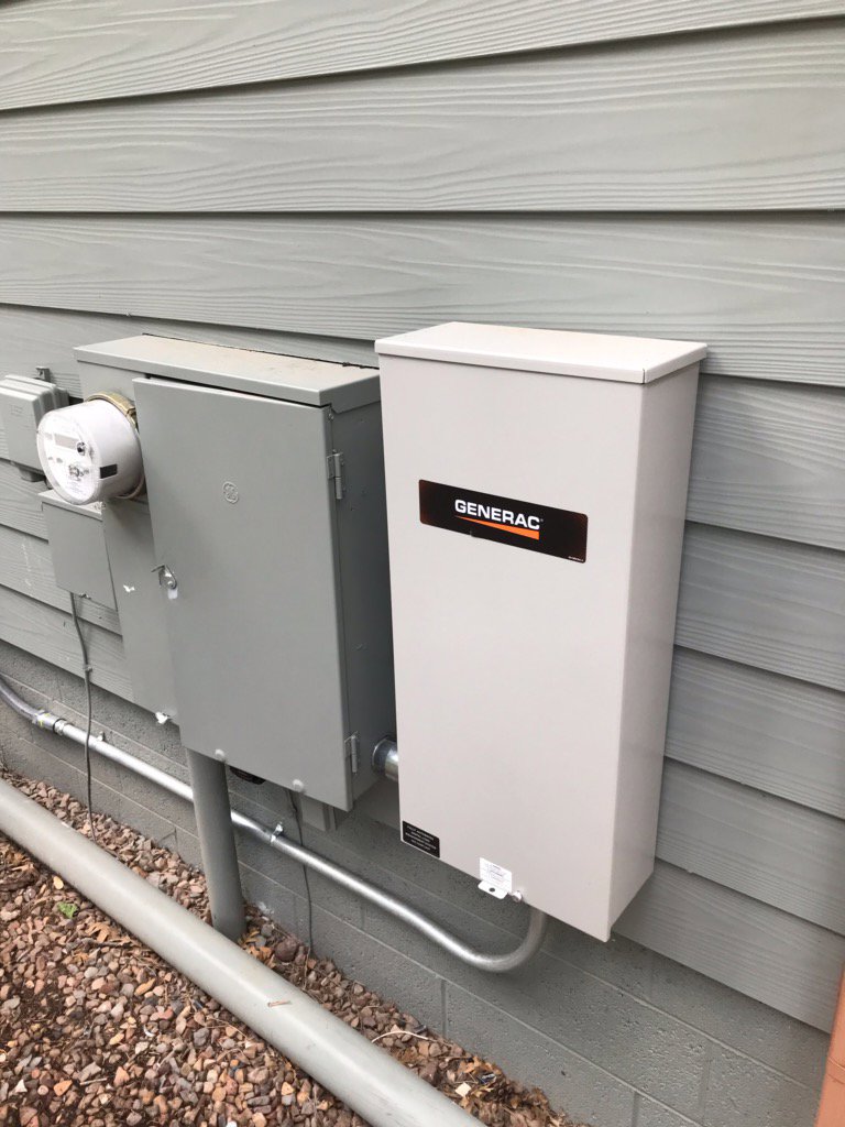 A Generac generator and associated electrical boxes and conduit installed by Johnson Power and Air in Gilbert, AZ.