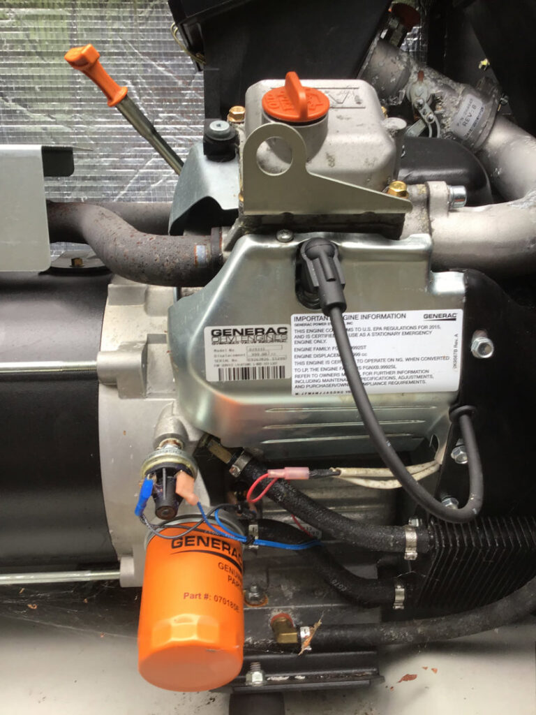 Close-up of Generac generator engine components and wiring during service by Washington Generators LLC in Kent, WA.