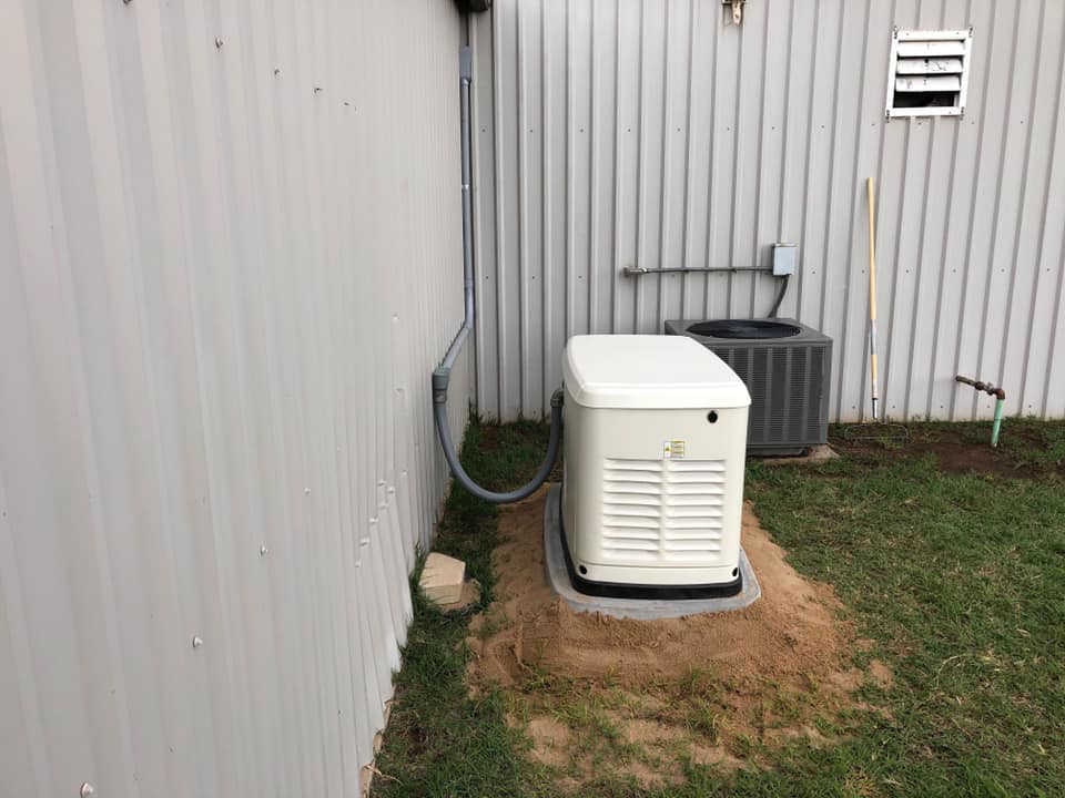An outdoor Generac generator unit installed next to a building by Burton Controls in Oklahoma City, OK.