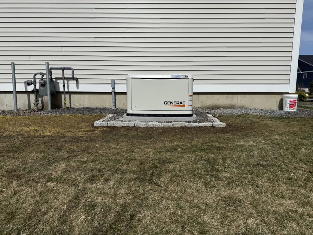 A Generac generator installation with visible gas meter and electrical conduit by Cason Power Solutions in Lowell, MA