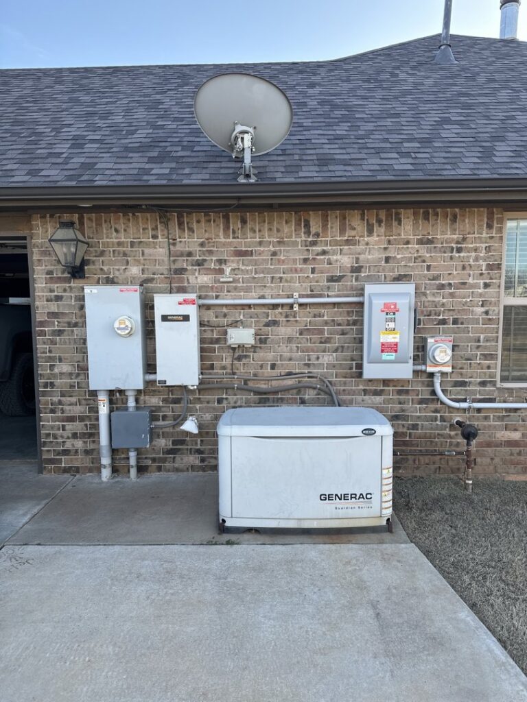 A Generac whole-home generator and electrical service panels installed on the exterior of a house by McLearen Electric in Piedmont, OK.