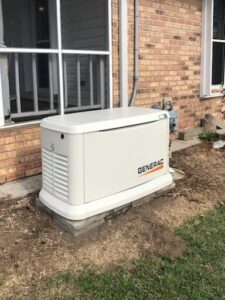 A Generac standby generator installed next to a brick residential home by K-Gen Electrical and Generator Services in Houma, LA.