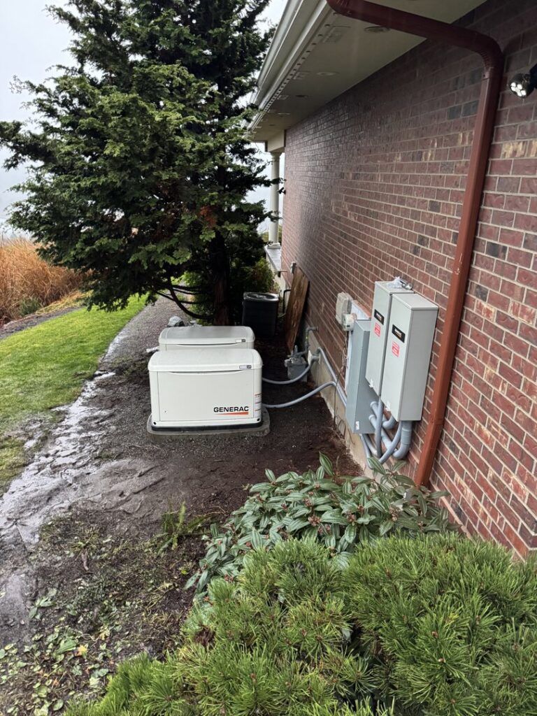 Two Generac standby generators installed outside a brick building, showing generator services by Mountain Coast Electric in Salem, OR