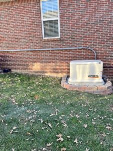 A Generac whole-home generator installed on a decorative stone base by Morris Electric Co. Inc. in Louisville, KY.