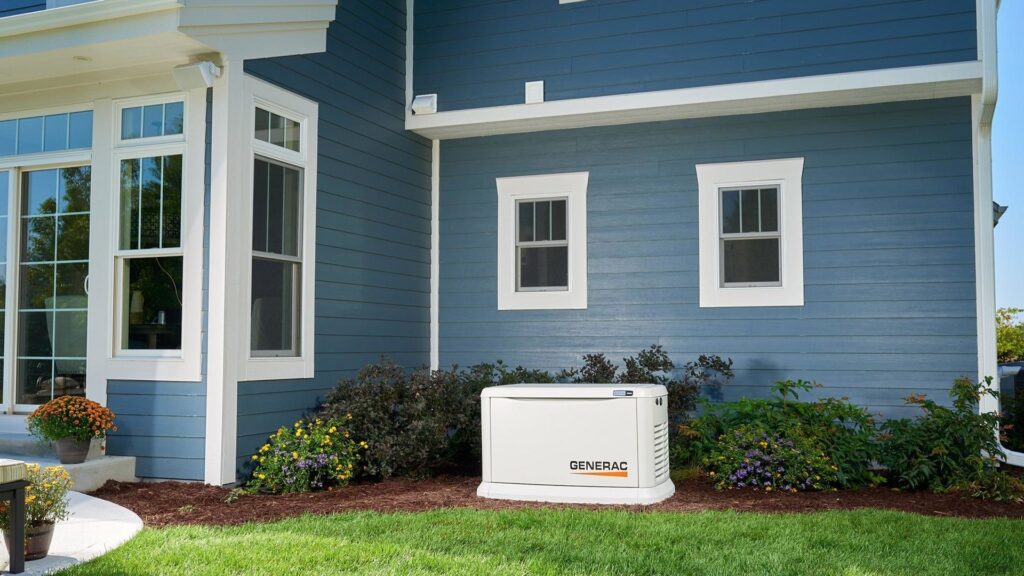 A Generac standby generator professionally installed at a blue house by Cenla Generators in Alexandria, LA.