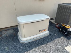 A Generac whole-home generator installed on a gravel bed next to an AC unit by Never Without Power Generators LLC in Huffman, TX.