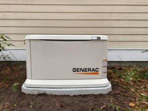 A Generac generator professionally installed on a concrete pad next to a residential building by Great Lakes Power Generation in Williamsburg, MI.