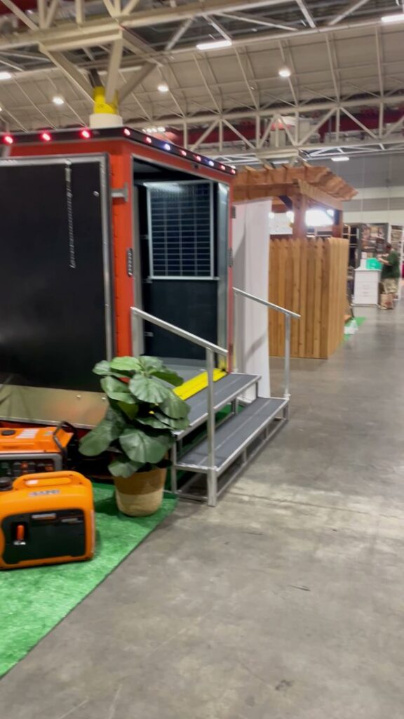 A trade show booth displaying a Generac generator and solar panel setup by Craig's Electrical and Generator Service in Kenner, LA.
