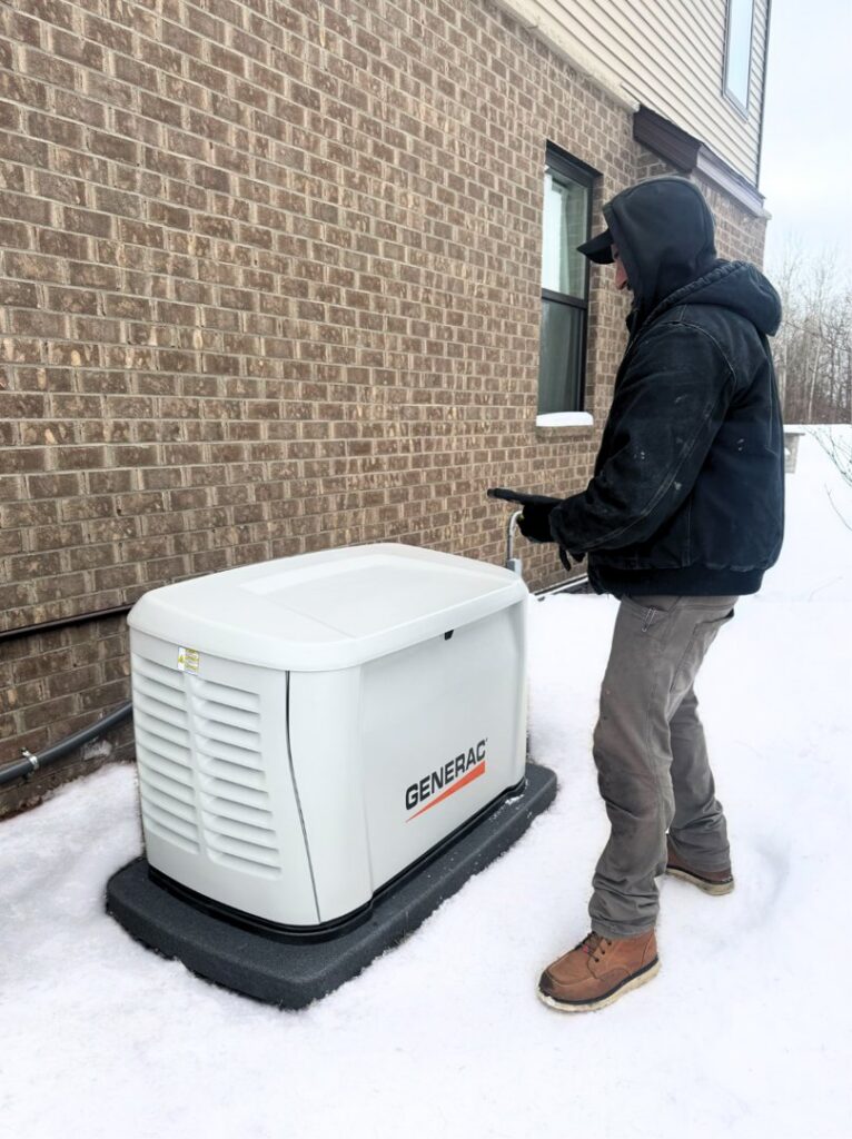 A Kelley Brothers LC technician testing a Generac standby generator during winter conditions in Livonia, MI.