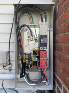 An open Generac generator transfer switch installation by Richard Sullivan Licensed Electrician in Brockton, MA.