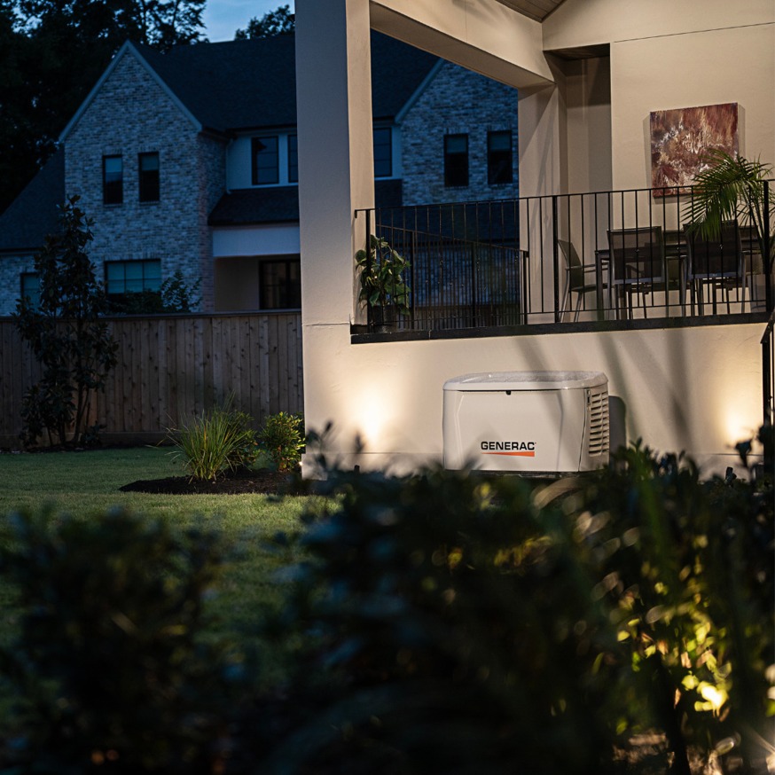A Generac home generator installed outside a residence at dusk by New Roads Genset in New Roads, LA.