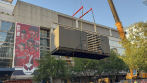 A Generac Industrial Power generator being lowered by a crane during installation by RSL Electric LLC in York, PA.