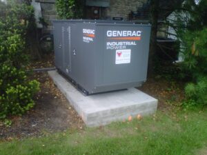 A Generac industrial power generator installed on a concrete pad by Varitech, Inc. in Louisville, KY.