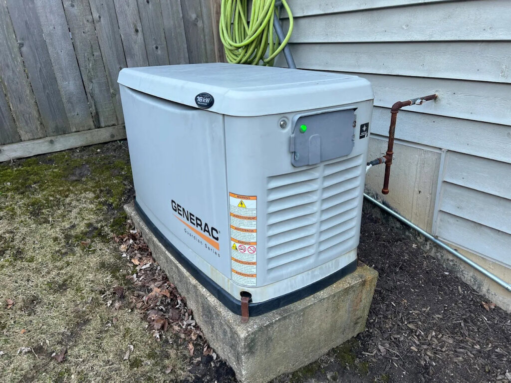 A Generac Guardian Series standby generator installed outside a home by Arnold Electrical Repair & Installation in Chicago, IL.