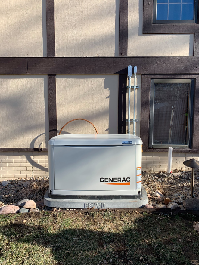 A Generac standby generator installed outside a home by Crown Enterprises Electrical Contracting in Omaha, NE.