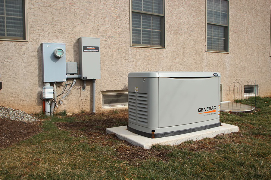 A Generac standby generator and electrical panels installed outside a building by LMS Energy in Milwaukee, WI.