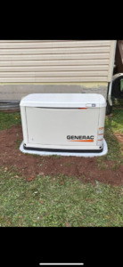 A newly installed Generac standby generator on a concrete pad next to a house by Moser Electric in Wisconsin Rapids, WI.