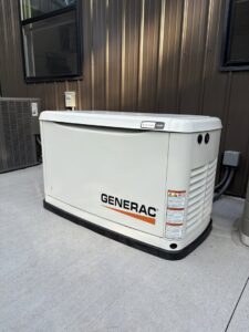 A Generac standby generator installed outside a building by Pure Light Electric in Kansas City, MO.
