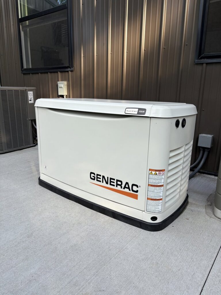 A Generac standby generator installed outside a building by Pure Light Electric in Kansas City, MO.