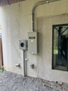An exterior Generac standby generator installation with electrical meter and conduit by Volt Doctors in Durham, NC