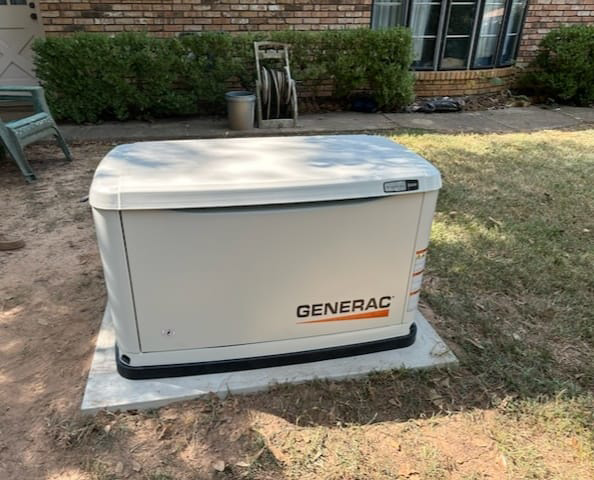 A Generac standby generator installed on a concrete pad in a residential yard by GenTec Service and Repair in Bossier City, LA
