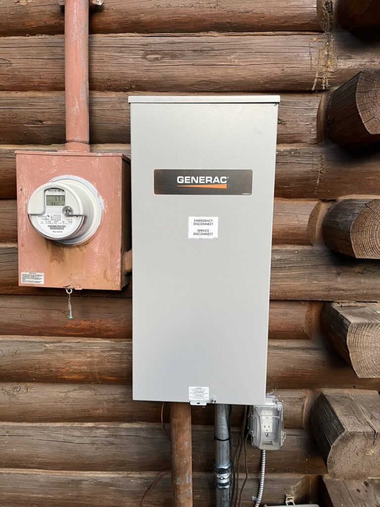 A Generac transfer switch and electrical meter installed on a log cabin by Mountain Electric in Knoxville, TN.