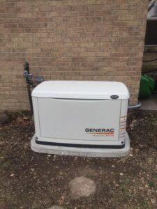 A Generac whole-home generator installed outside a brick house by Mr. Electric of Rogers in Rogers, AR.