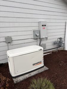 A Generac whole-house generator installed next to a residential building, a service provided by ACI Northwest Heating, Cooling & Electrical in Dalton Gardens, ID.