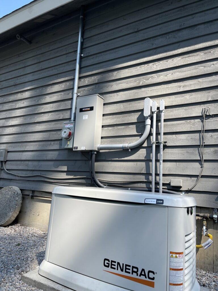A Generac whole-house generator installation with electrical conduit and meter by Interstate Electrical Contractors in Dalton Gardens, ID.