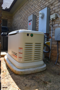 A Generac whole-house generator professionally installed outside a home by Precision Electric and Lighting Services in Olive Branch, MS.