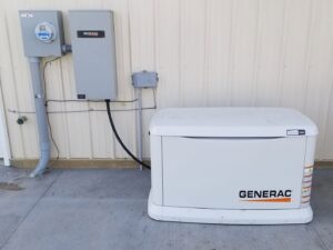 A Generac whole-house generator installed next to an electrical meter and service panel by Warner Electric Service, LLC in Broken Arrow, OK.