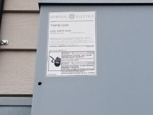 Close-up of a General Electric electrical panel label with safety warnings by Cargo Electric LLC in Philippi, WV