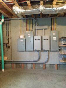 Multiple electrical panels and Generac generators installed on a wall by All City Electrical in Orlando, FL